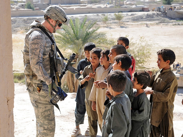 military taking with local children