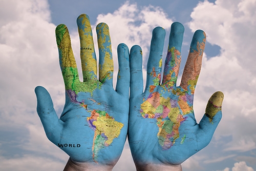 Hands with world map