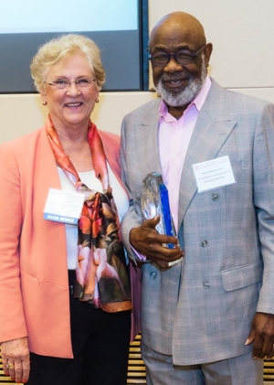 Dean Marilyn Flynn, left, presents Moses Chadwick with the Exemplar Award from the Network for Social Work Management in 2016
